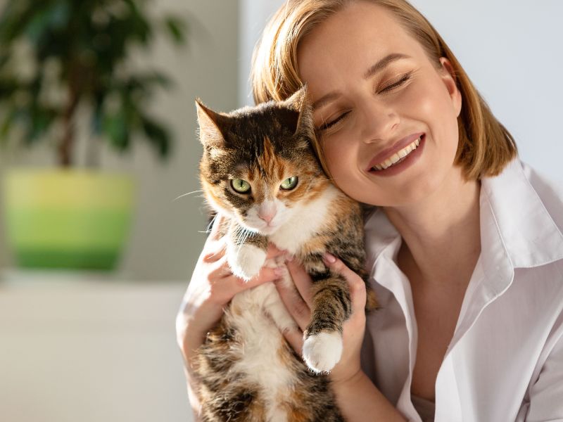 Woman happily holding cat Woman happily holding cat