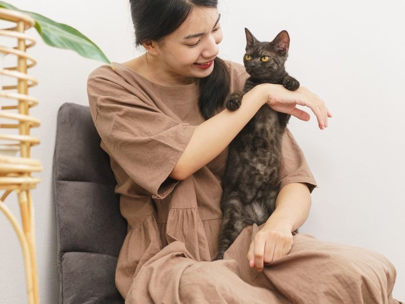 Woman holding black cat Woman holding black cat